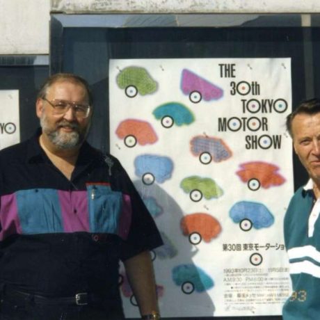 karl ullman and friend standing in front of motor show posters