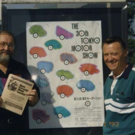 men standing together smiling at motor show