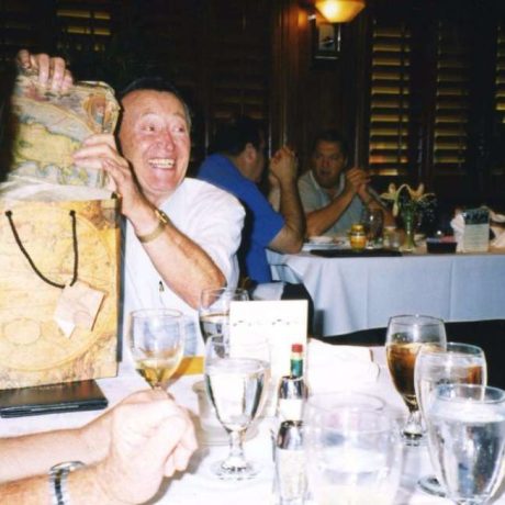 man smiling with gift at event