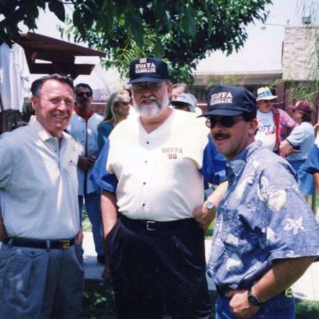 photo of men standing together at event