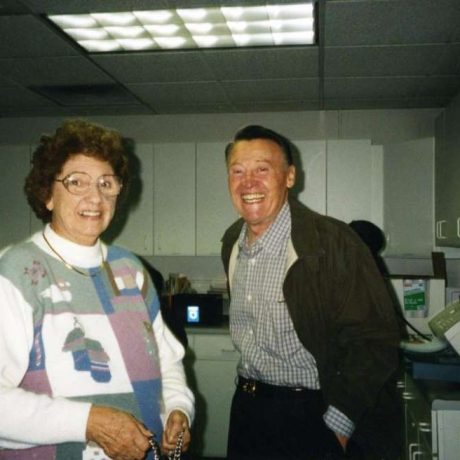 photo of man and woman smiling in office setting