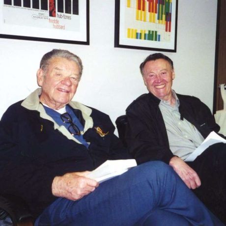 photo of two men smiling together seated